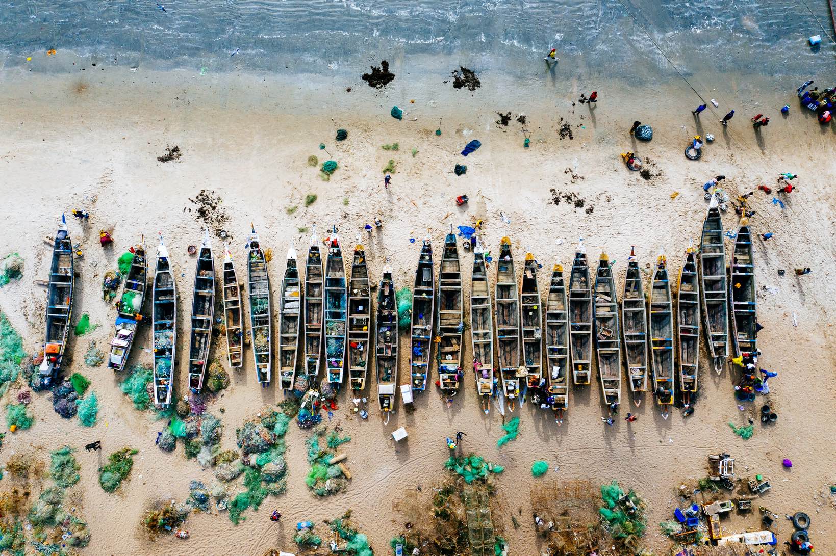 overhead-aerial-shot-different-colored-boats-sandy-beach-with-sea-nearby-2